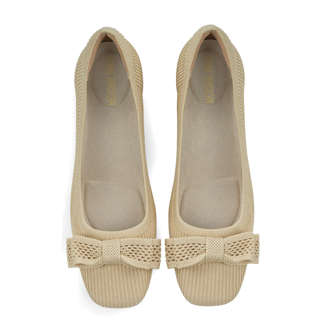 Pair of beige shoes with a bow detail on a white background#color_beige