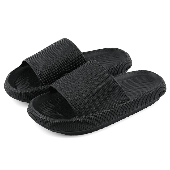 A pair of black slide sandals with textured straps and ridged soles, shown on a plain white background.#color_herringbone-black
