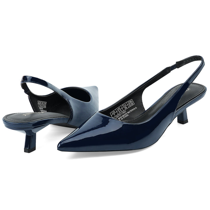 A pair of navy blue patent leather slingback kitten heels on a clean white background.#color_navy
