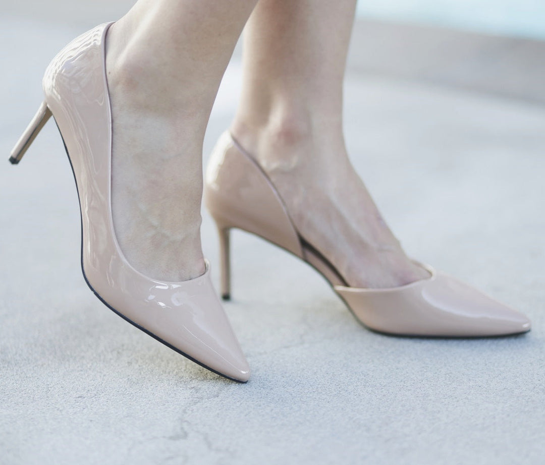 Beige high-heeled shoes on a light background#color_nude