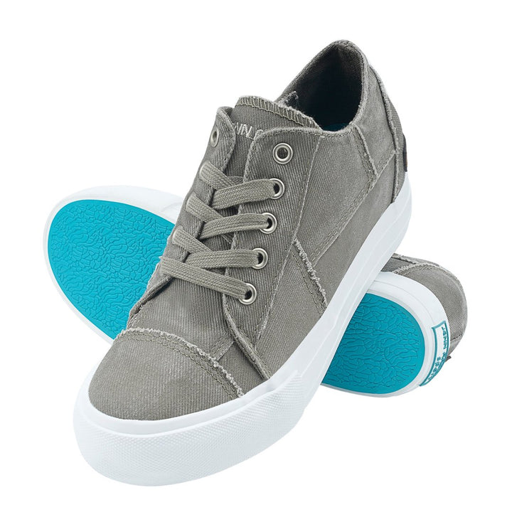 Gray sneakers with turquoise soles on a white background#color_grey1