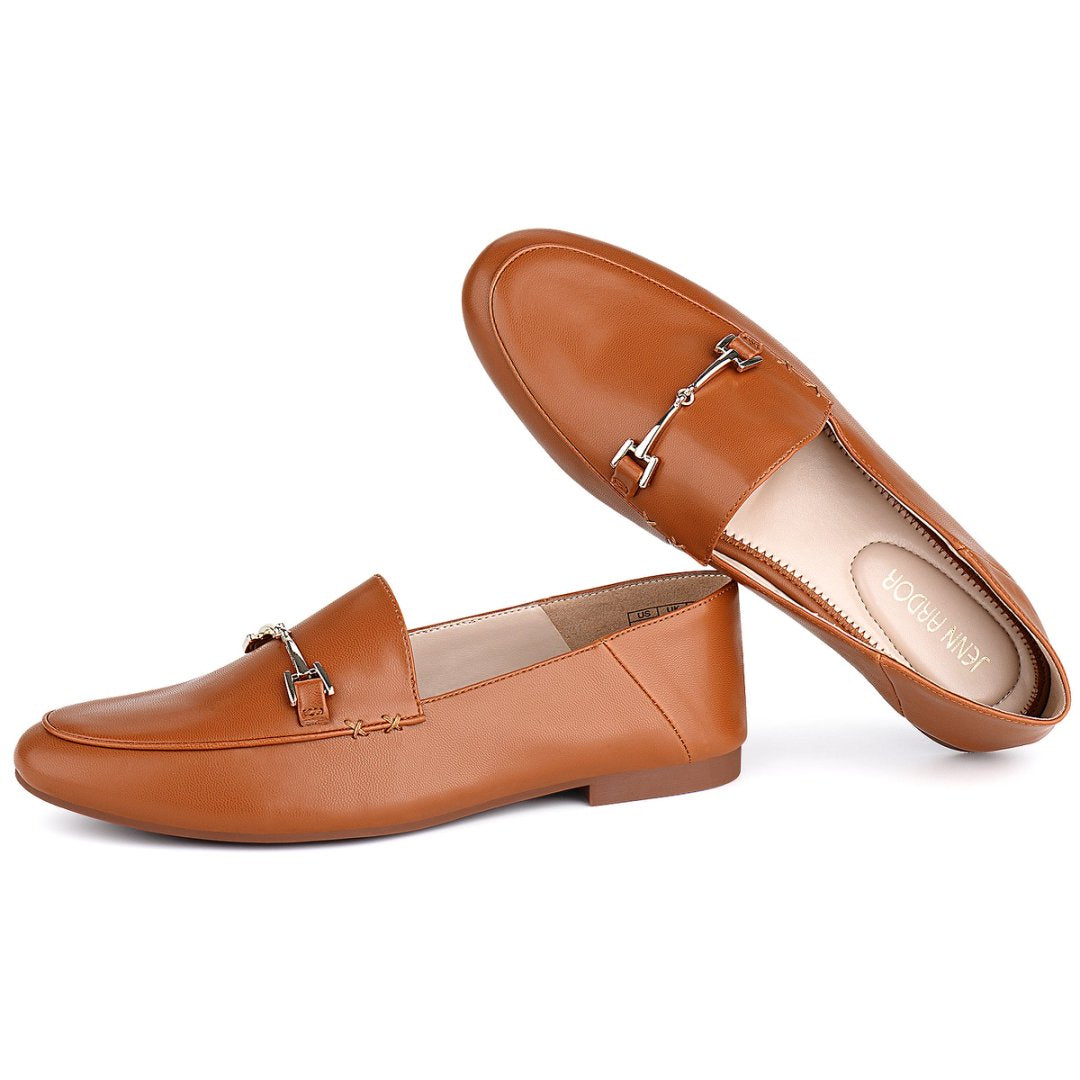 Pair of brown loafers with a silver buckle on a white#color_brown
 background#color_brown