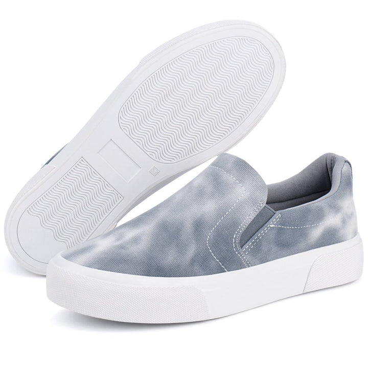 Pair of light blue slip-on sneakers with white soles on a white background#color_grey-tie-dye