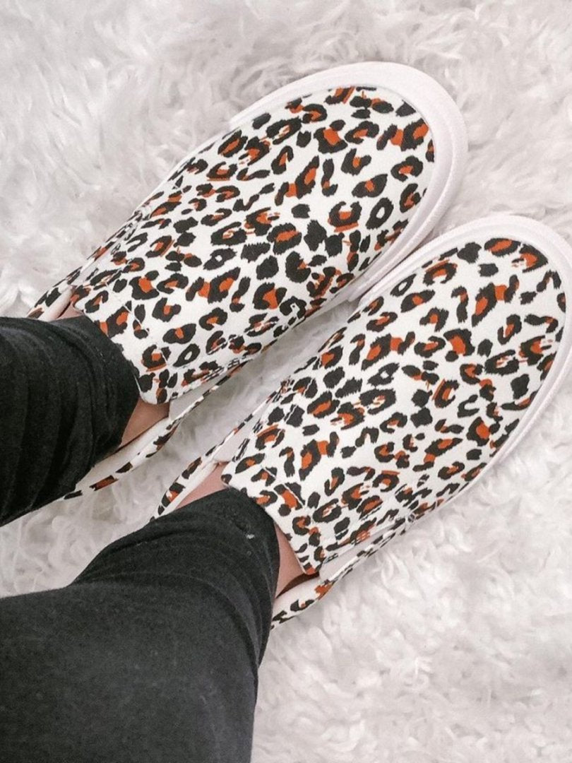 Leopard print slip-on sneakers on a light gray background#color_spot