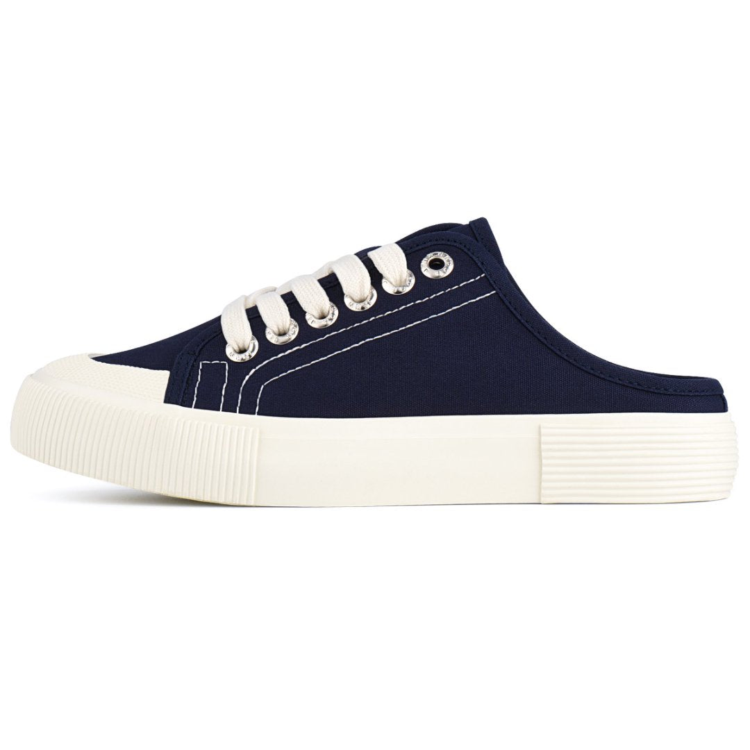 Navy blue slip-on shoe with white laces on a white background#color_blue