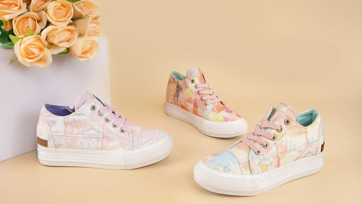 Colorful high-top sneakers on a beige surface with flowers in the background#color_orange