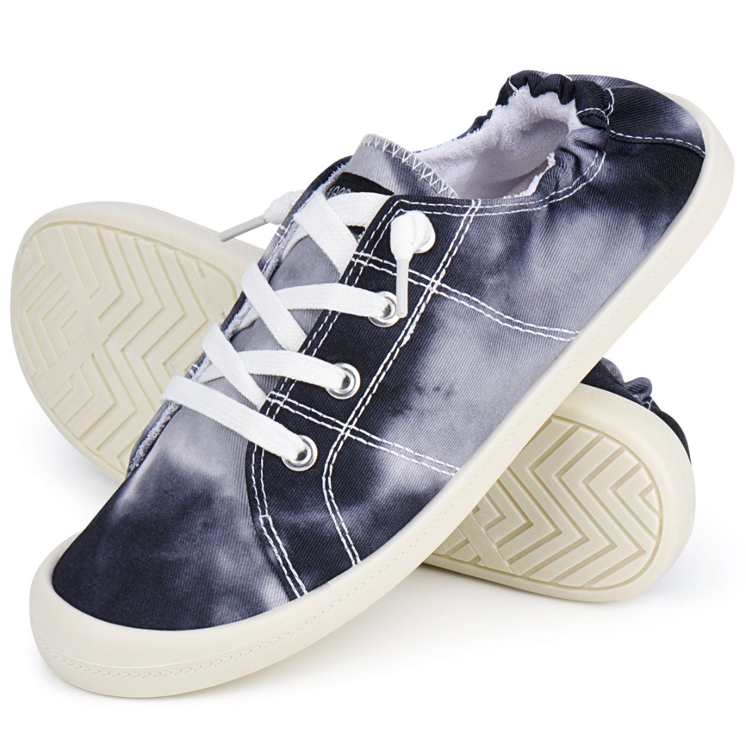 Pair of blue tie-dye sneakers with white laces on a white background#color_black-tie-dye