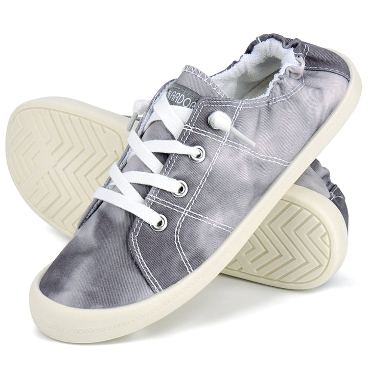 Pair of gray sneakers with white laces and soles on a white background#color_grey-tie-dye