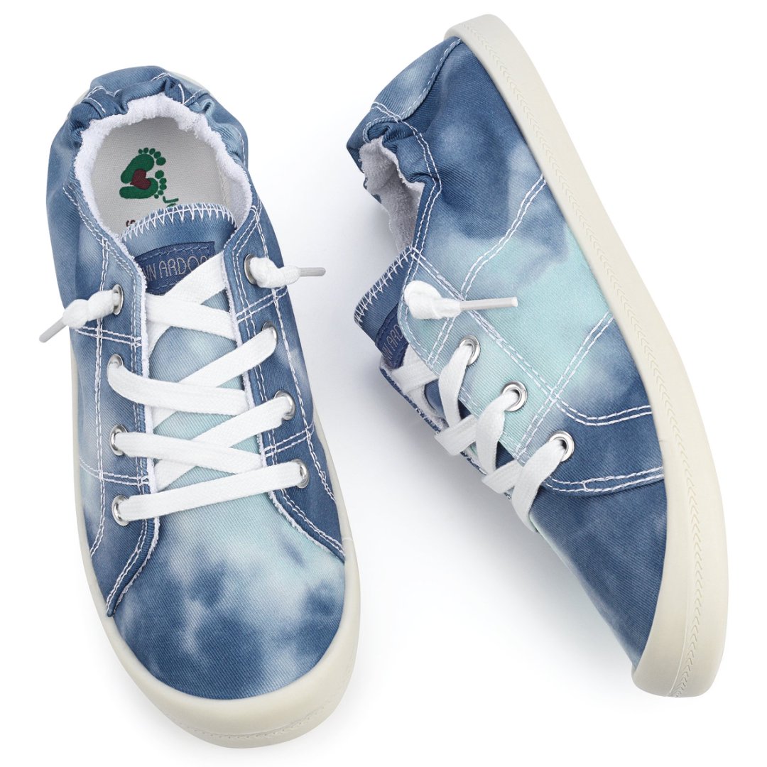 Pair of blue tie-dye sneakers with white laces on a white background#color_blue-tie-dye