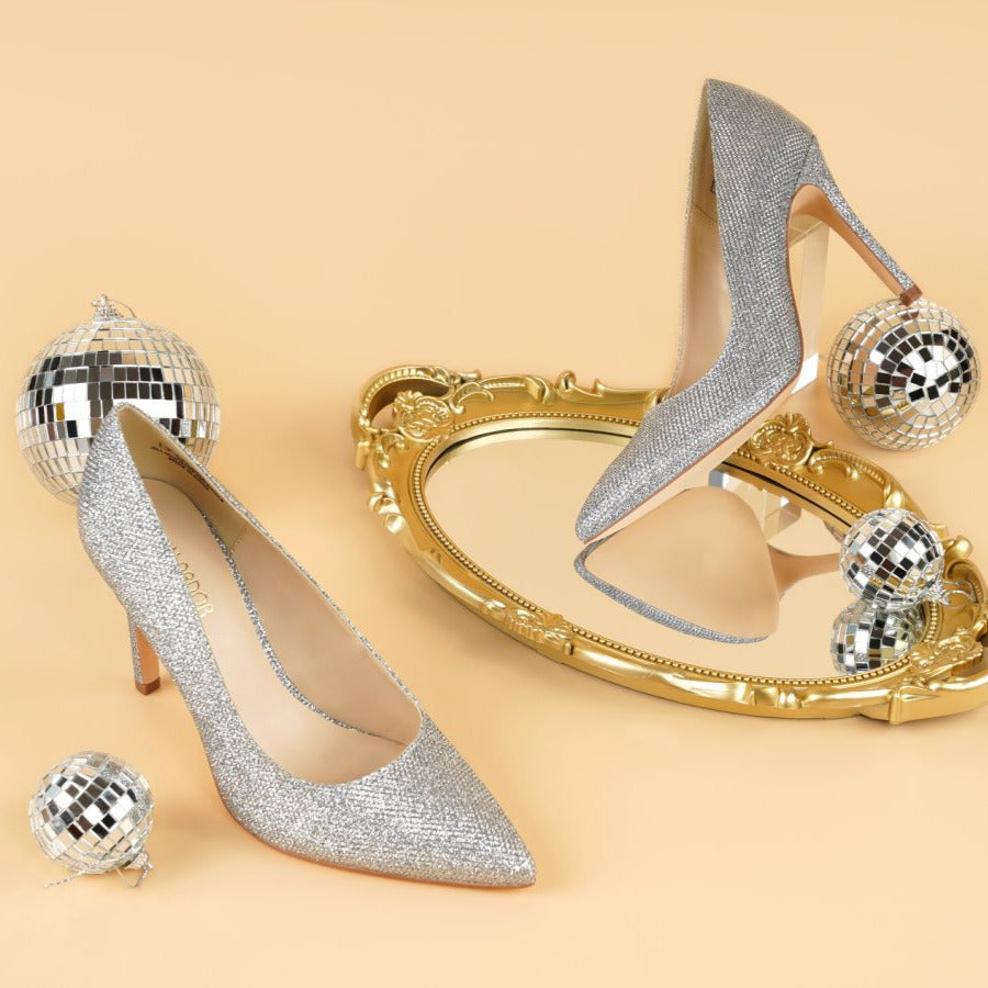Silver high-heeled shoes with decorative elements on a beige background#color_silver