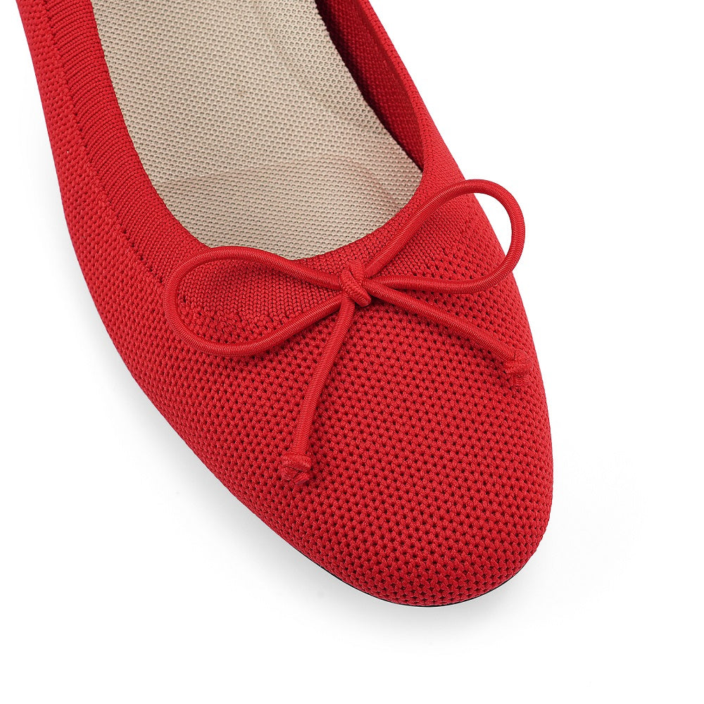 Red ballerina shoe with a bow on a white background#color_red