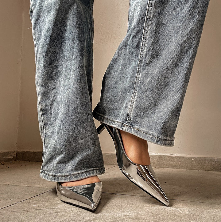 silver slingback pointed kitten heels styled on feet#color_silver